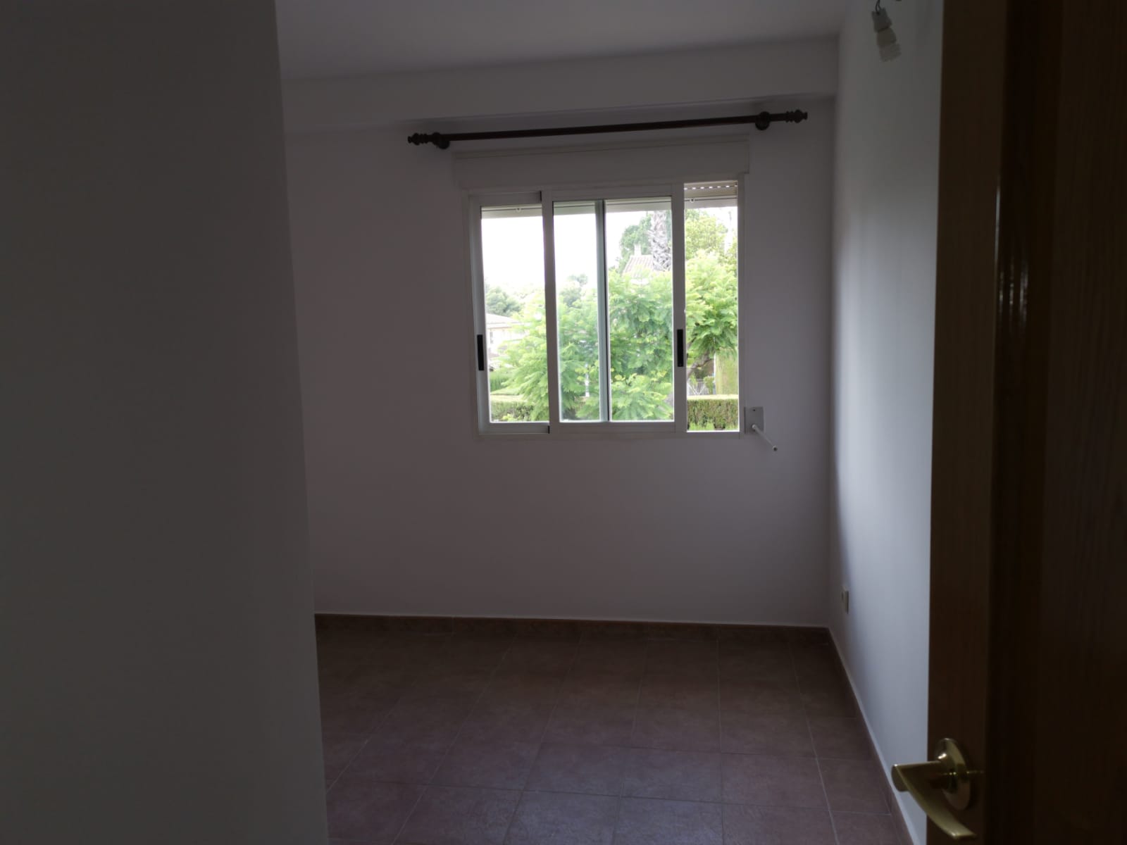Bright bedroom with a window onto greenery (provisional photo).